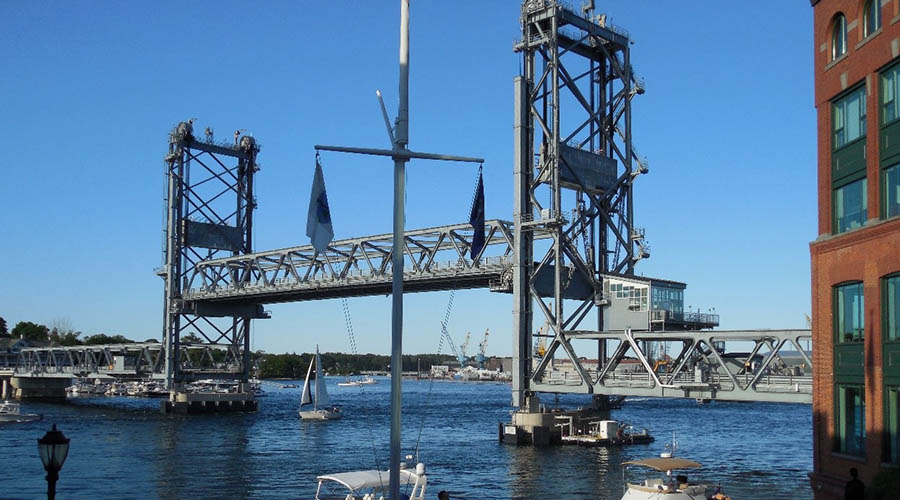 Memorial Bridge with raised span over the Piscataqua River on a sunny day with boats